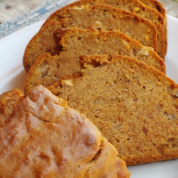 Slices of sweet potato apple quick bread arranged on a white plate.