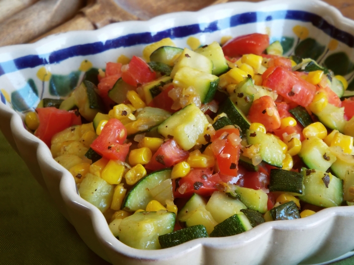 Bowl of sautéed zucchini with corn and tomatoes